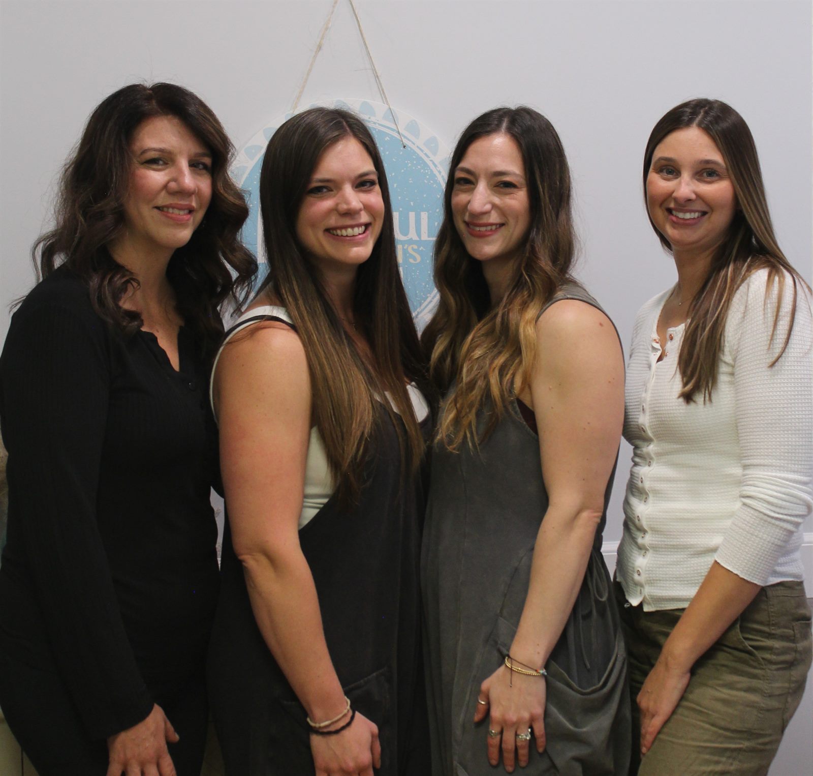 The Powerful Women's Health team in front of the office sign